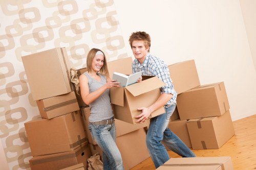 Careful packing of household items in Chelsea with protective wrapping and labeled boxes