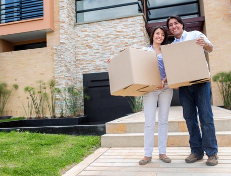Movers handling furniture during a home relocation